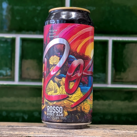 Colorful beer can with 'Triple Point Brewing' branding on a wooden surface.